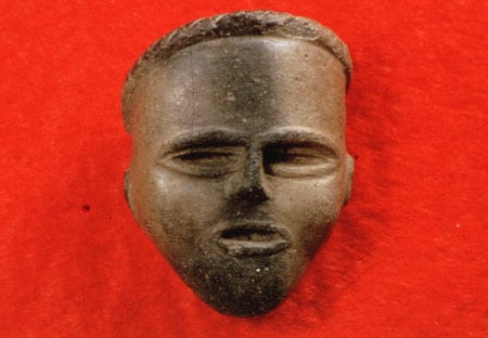 Clay effigy face, likely once attached to a tobacco pipe