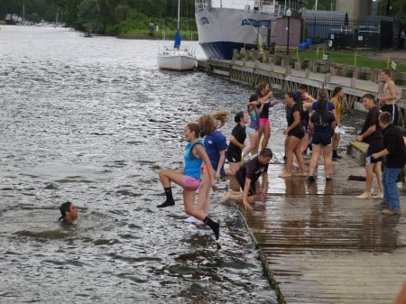 Students with the Kingston High School rowing program jump in the Rondout Creek in 2013.